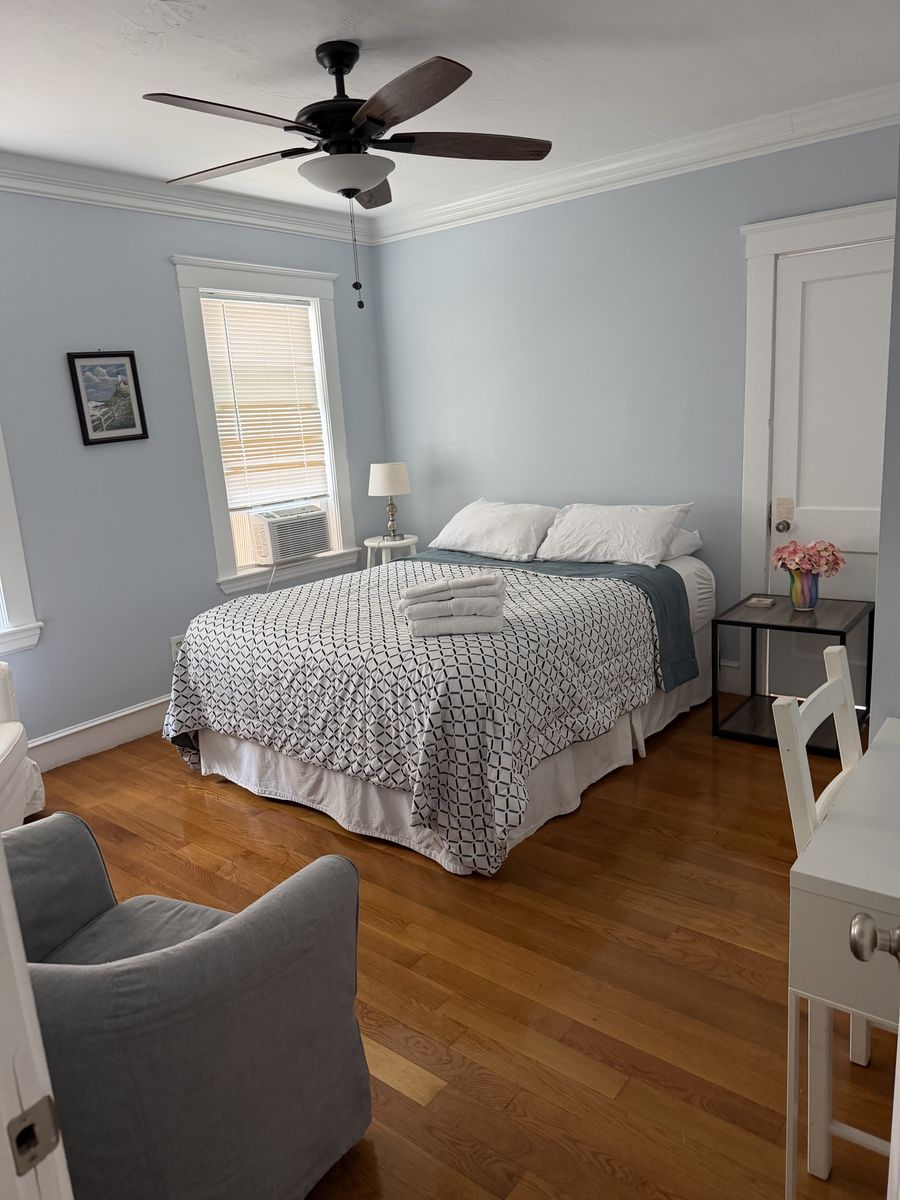 Guest bedroom with fresh towels folded on the bed