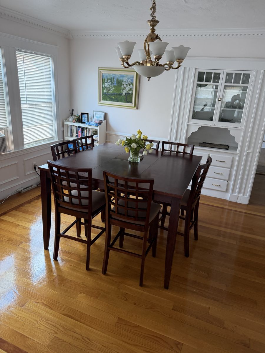 Dining room with a polished table and shining hardwood floor